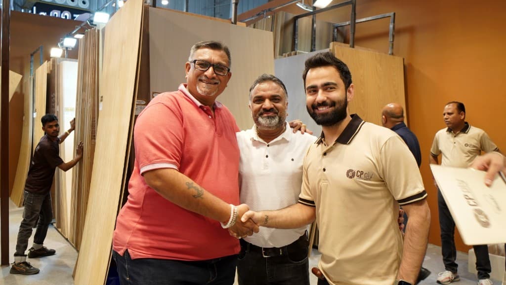 Partnership handshake at the CP Ply exhibition stall